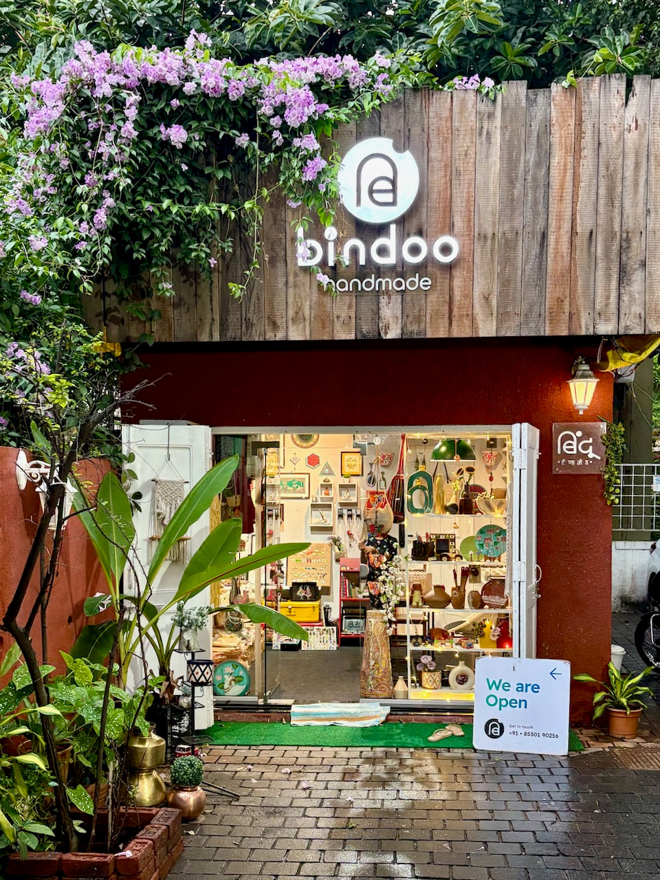 Storefront of bindoo handmade with decorative elements and 'We are Open' sign.